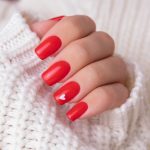 Beautiful,Female,Hand,With,Red,Manicure,Nails,,Hearts,And,Valentine’s